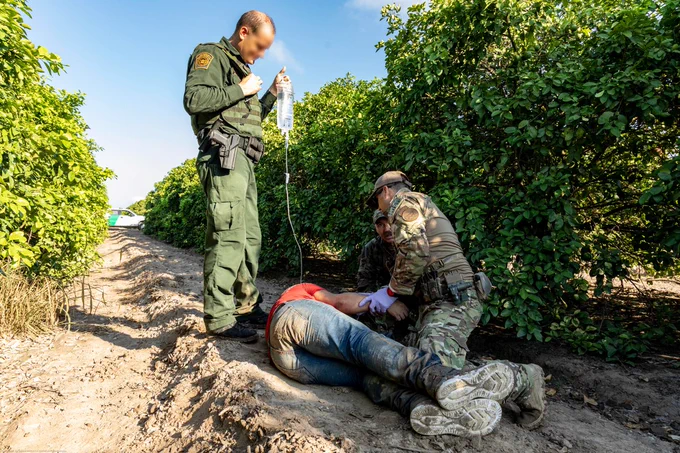 A BORTSTAR and BP agent giving aid to a man.