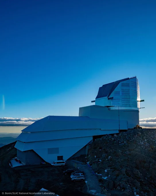 Angular silver observatory on a rocky mountaintop at blue twilight. 