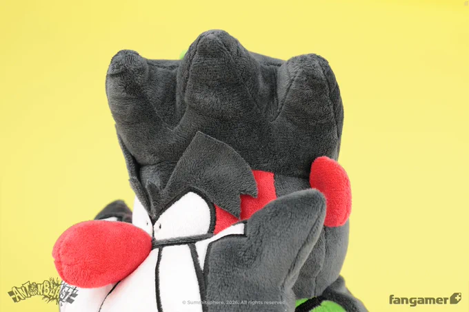 A closeup photo of the Dynamite Anton plush, showing its embroidered facial details and the complex plush shapes used to create its eyebrows and hair. 