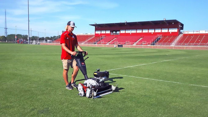 Easton Petsche mows the turfgrass at the Barbara Hibner Soccer Stadium field.