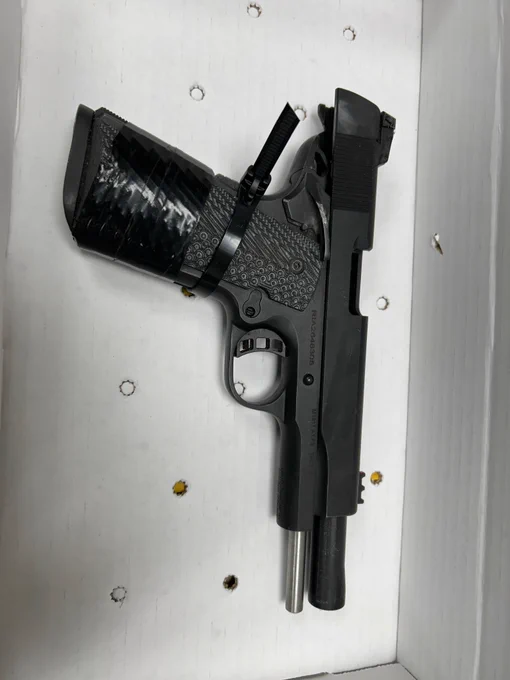 Photograph of a black semi auto pistol seized during a traffic stop.