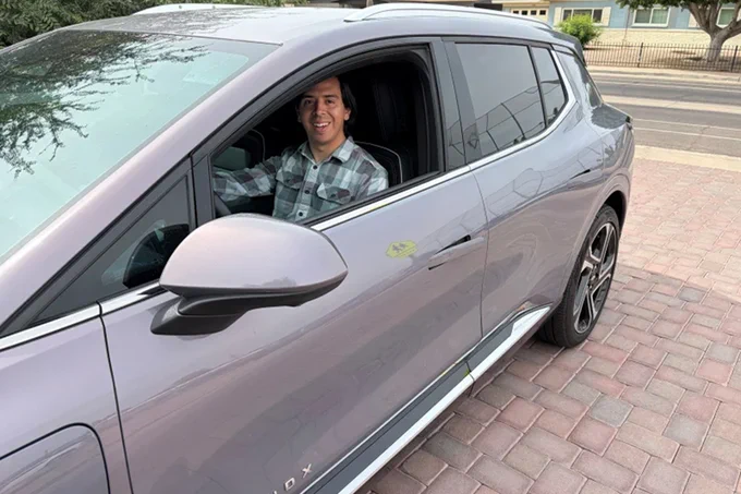 Guadalupe Higuera behind the wheel of his 2025 Chevrolet Equinox EV in Phoenix, Ariz.

Jeff Brady/NPR