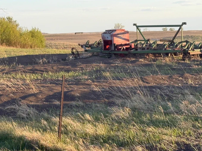 Farming equipment sits in dirt in a field. Photo taken in Williams County, North Dakota, on May 25, 2026. Description from CMOR user: “Top soil that has blown off of the fields. Driving through dirt drifts while hauling cattle to pastures. Finding dirt collected in ditches, prairie trails, and burying the pasture grass, leaving the fields with exposed rocks.
Rain total (so far) for the month of May is 0.39 in. Wind blew 65 mph 2 weeks ago.”