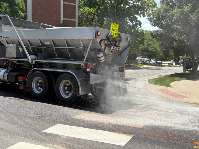 Crews apply Reclamite to South Fifth Street, June 2, 2026.