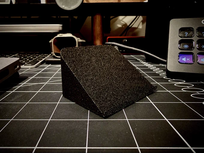 3D printed wedge that holds an iPhone at a perfect 35 degree angle, making it easy to access when used with an Apple Magic Trackpad.