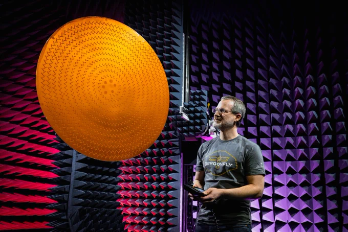 Dragonfly lead antenna designer Matt Bray inspects Dragonfly’s high-gain antenna, or HGA, in a test chamber at the Johns Hopkins Applied Physics Laboratory in Laurel, Maryland. The HGA is a radial line slot antenna that uses many small slots working together to create a narrow, focused radio beam. The cones in the background are special absorbers that soak up stray radio waves, making the room act more like open space. (Credit: NASA/Johns Hopkins APL/Ed Whitman)