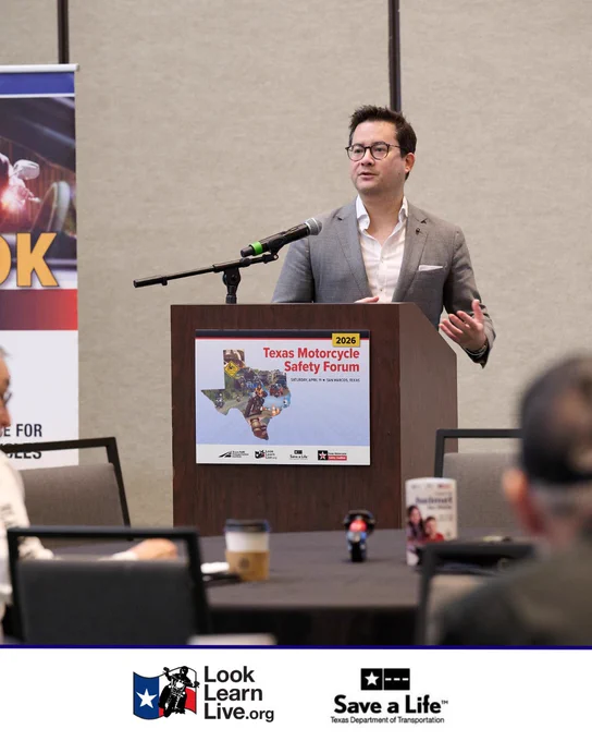 A person stands at a podium speaking at the 2026 Texas Motorcycle Safety Forum. 