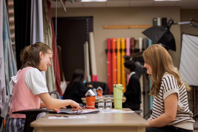 student sits for photo review