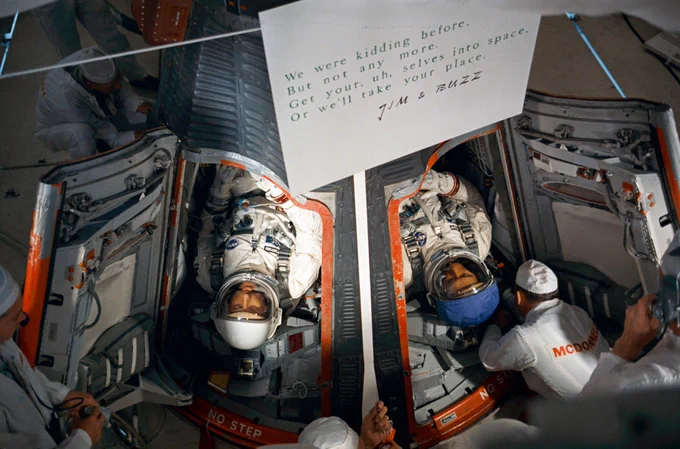 Technicians prepare to close the hatches on the Gemini-9A spacecraft in the White Room atop Pad 19 after insertion of astronauts Thomas P. Stafford (left) and Eugene A. Cernan. Liftoff was at 8:39 a.m., June 3, 1966. A note from the backup crew, Jim Lovell and Buzz Aldrin, is seen in the foreground. It reads "We were kidding before, But not any more. Get your, uh, selves into space, Or we'll take your place." Photo credit: NASA