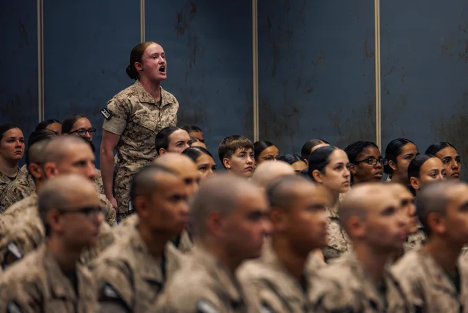 A U.S. Marine Corps candidate with Officer Candidate School, Company L, reads a powerpoint slide during a brief prior to the Company L pick-up at OCS on Marine Corps Base Quantico, Virginia, May 22, 2026. During pick-up, the candidates meet their sergeant instructors for the first time, who they will be with for their entire training cycle. (U.S. Marine Corps photo by Cpl. Braydon Rogers)