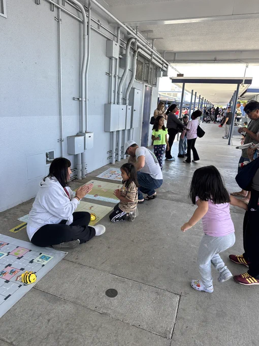 Ashley Ruiz playing robotics activity with students from 186th Street Elementary School