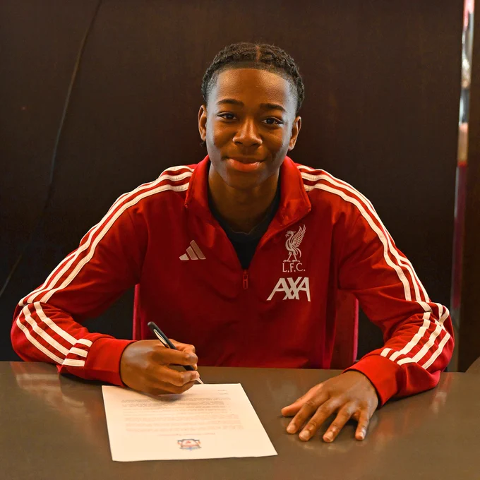 A photo of Daniel Majekodunmi signing their LFC scholarship at Anfield