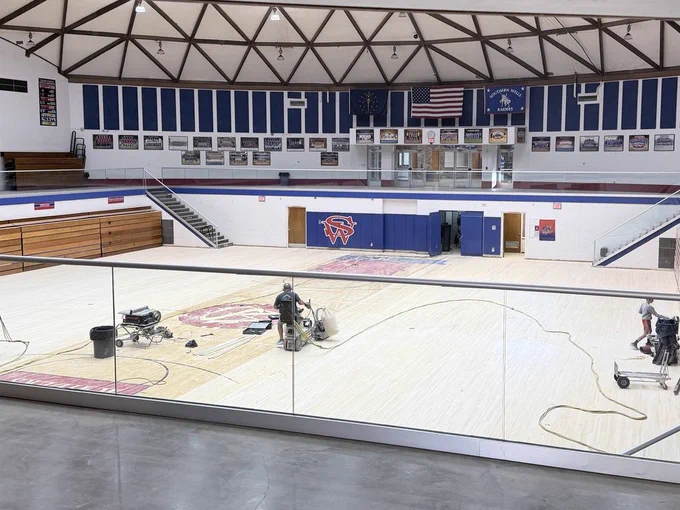 Gym floor being sanded down and prepared for an updated design!