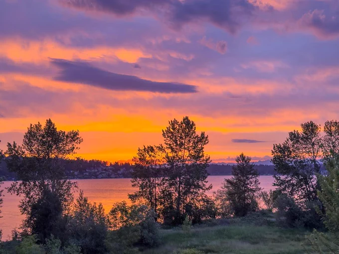 A mix of orange and pink with the sunrise this morning over the Cascades, with clouds refracting the sunlight.