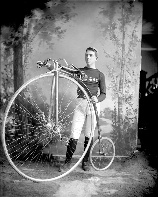 E. L. Laliberté posing with a high wheel bicycle