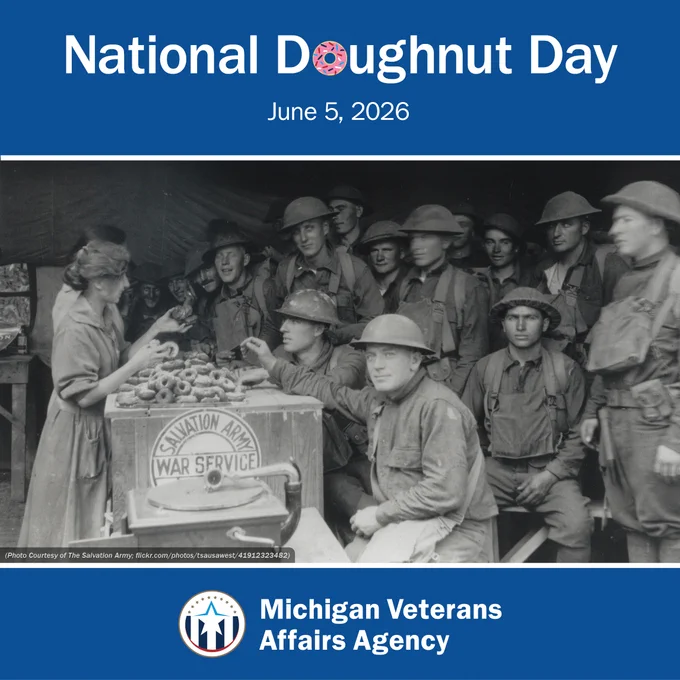 Black and white image of a woman handing out doughnuts to over 20 soldiers inside a tent. Text says 'National Doughnut Day. June 5, 2026.' With the Michigan Veterans Affairs Agency logo
