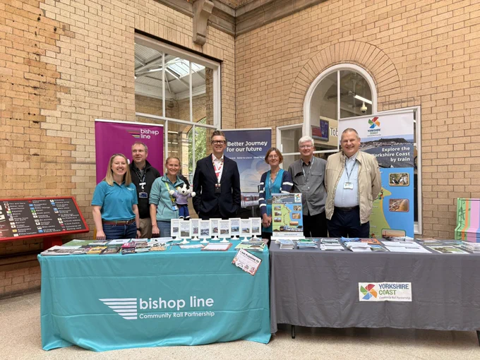 Myself and colleagues from community rail partnerships at York station in front of tables covered in leaflets