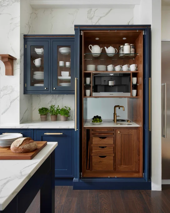 Wooden bantry with pocket doors, sink and microwave.