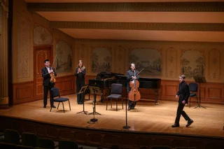 Photo of BMS eighth-grader Anton Bekeny has members of the cleveland orchestra finish playing his composition.