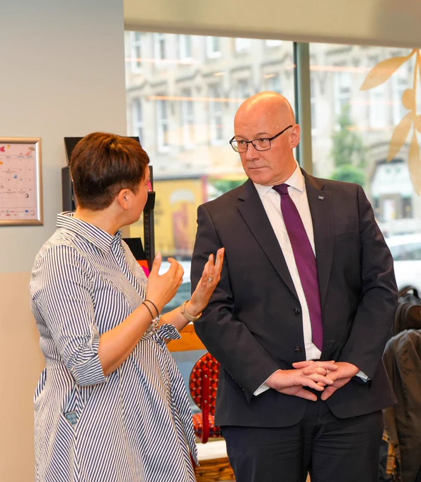 First Minister John Swinney speaking to a woman at SAMH's The Nook.