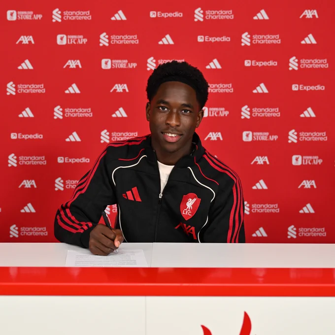 A photo of Josh Abe signing their LFC scholarship at Anfield