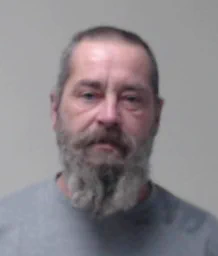 A middle-aged man with a grey beard and receding hairline, looking at the camera.