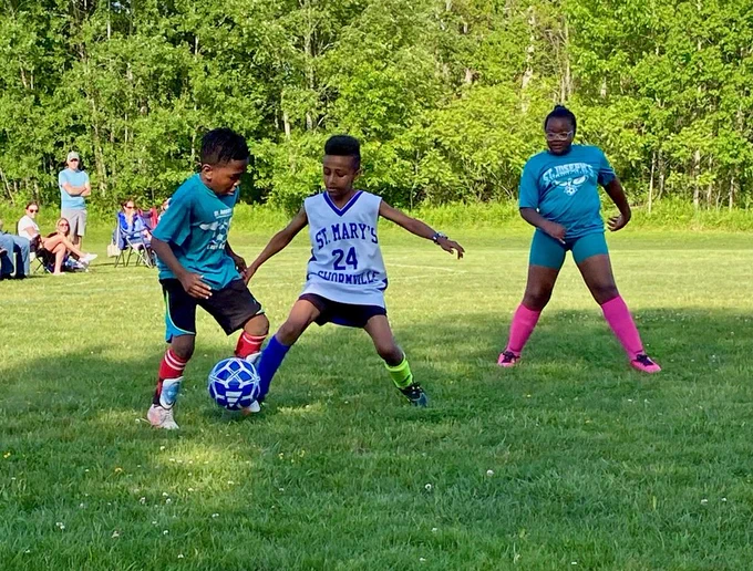 SMS grade 3 & 4 soccer players on the field during their last game of the season