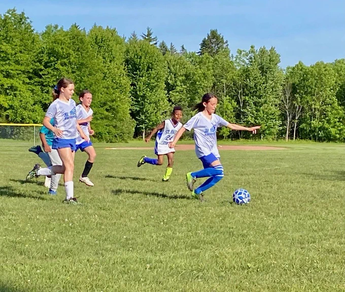 SMS grade 3 & 4 soccer players on the field during their last game of the season