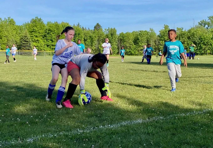 SMS grade 3 & 4 soccer players on the field during their last game of the season