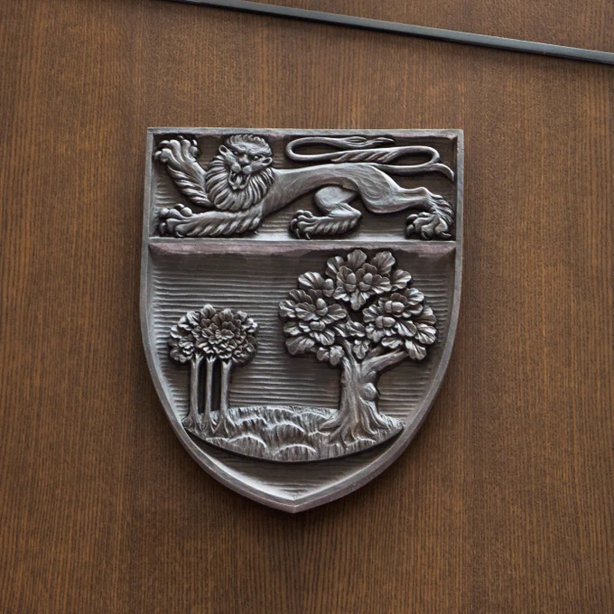 The coat of arms for the province of Prince Edward Island, featuring a mature oak tree, three oak saplings, and the lion passant. 