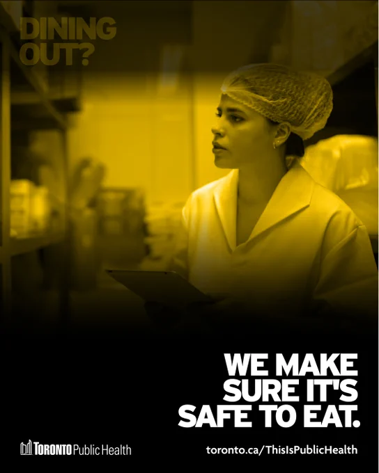 Shows a yellow-toned photo of an inspector in a restaurant wearing a hair net. Now the top text ‘Dining out?’ is faded, and the text underneath is bright, ‘We make sure it’s safe to eat.’