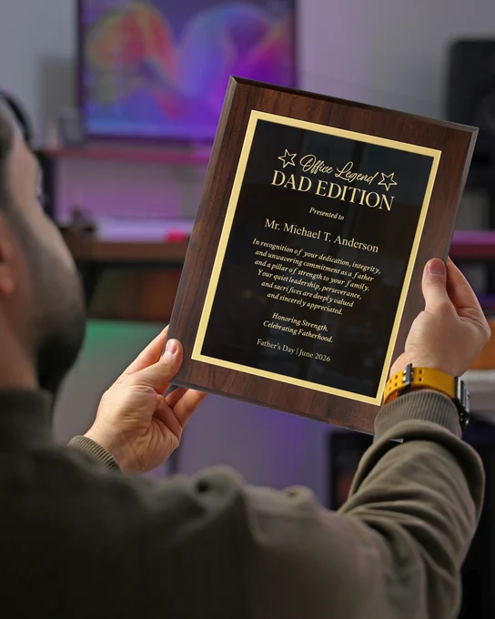 Man In Office Holding Up Custom Black Metal Plaque With Wood Board And Engraved With Office Legend Dad Edition Message
