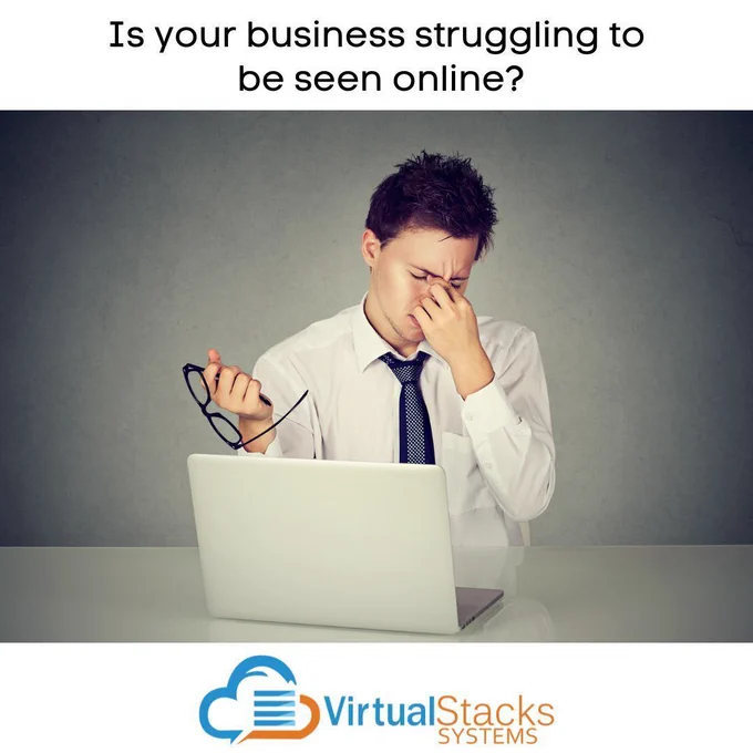 Young businessman with worried facial expression in front of open laptop; Virtual Stacks Systems logo.