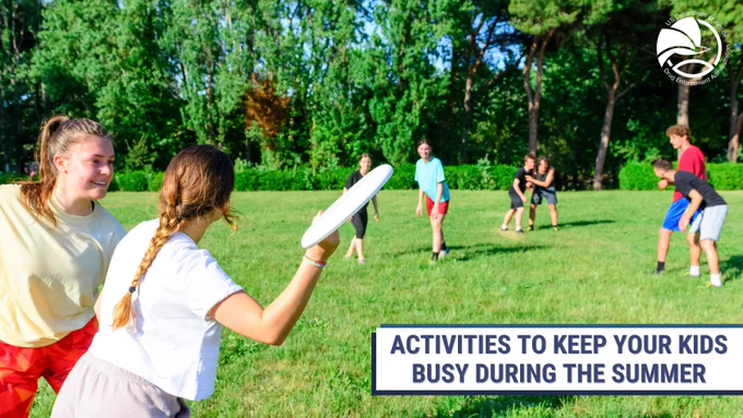 Children playing frisbee on a sunny grassy field surrounded by trees during summer. With a text overlay saying "Activities to keep your kids busy during summer" 