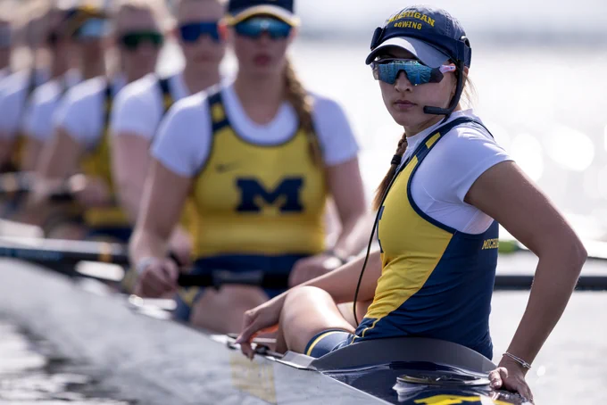 Logan Roeder looking in direction of camera from rowing shell