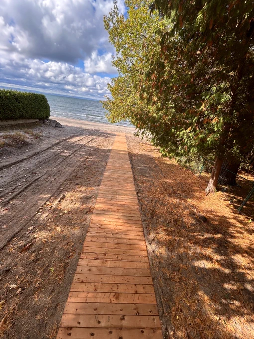 An accessible wooden boardwalk that leads to Cawaja Beach.