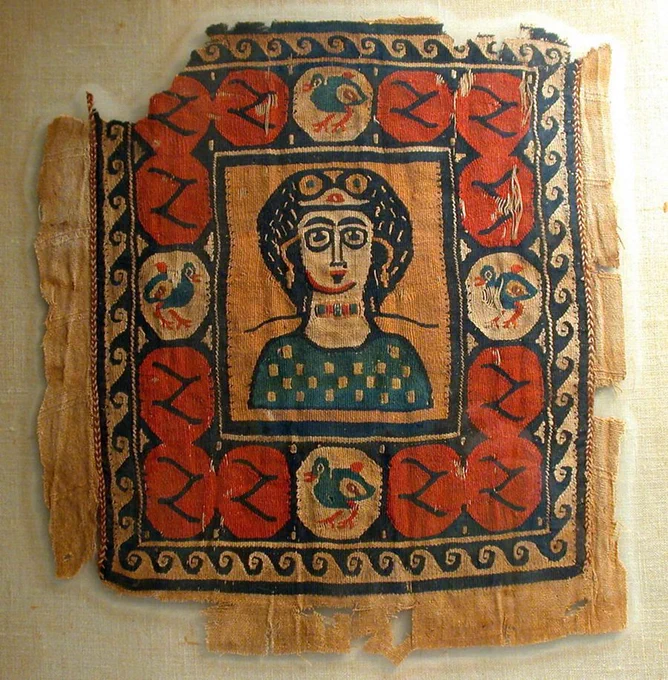 Saint Scholastica on a sofa cushion. She's Benedict's sister, and shows up in one of our stories because Late Roman saints are also post-apocalyptic.