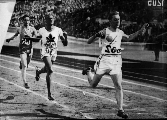 Three athletes competing in the men's 800-metre race at the 9th Summer Olympic Games