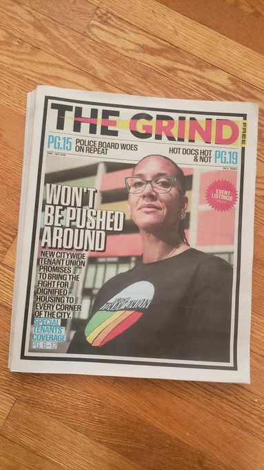 Photo of the print edition of The Grind newspaper with headline "Won't Be Pushed Around: New Citywide Tenant Union Promises to Bring the Fight for dignified Housing to Every Corner of the City." There is a photo of a black woman in front of a building on the cover, wearing a black Toroto Tenant Union t-shirt.