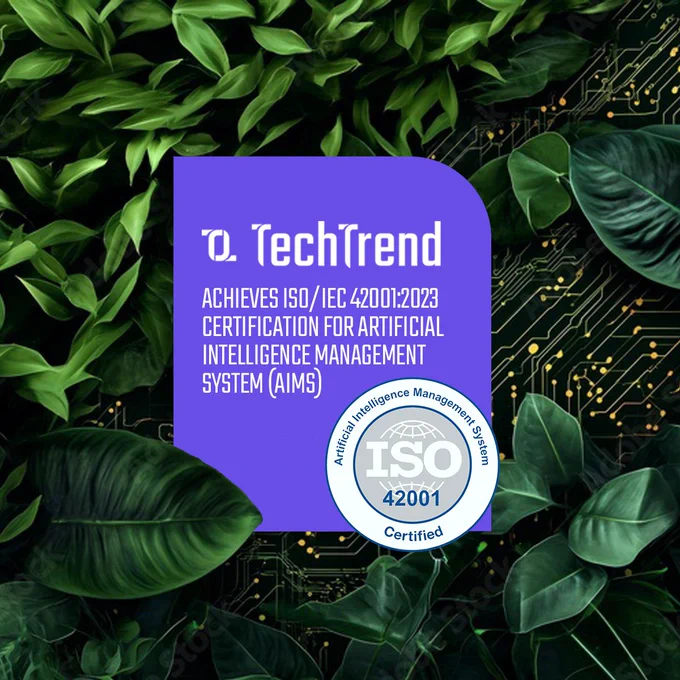 A digital graphic featuring a purple rectangle with the TechTrend logo. Text reads: "Achieves ISO/IEC 42001:2023 Certification for Artificial Intelligence Management System (AIMS)." Surrounding the rectangle are green leaves and a circuit board design. A certified ISO 42001 emblem is visible.