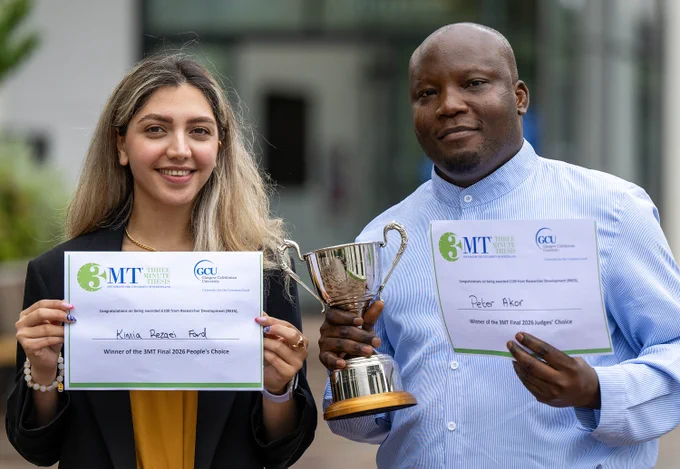 Two individuals holding certificates and a trophy, celebrating their wins at the 3MT Final 2026 event.