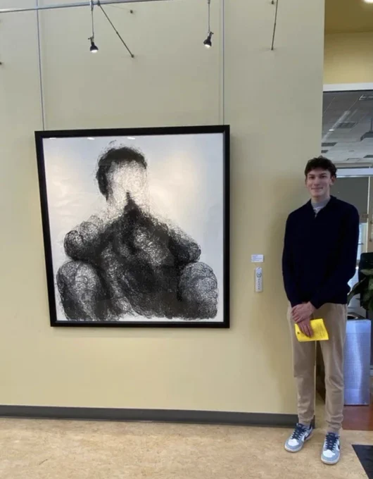 BBHHS Class of 2026 graduate Ben Mehendale stands next to his artwork, Made of the Mind