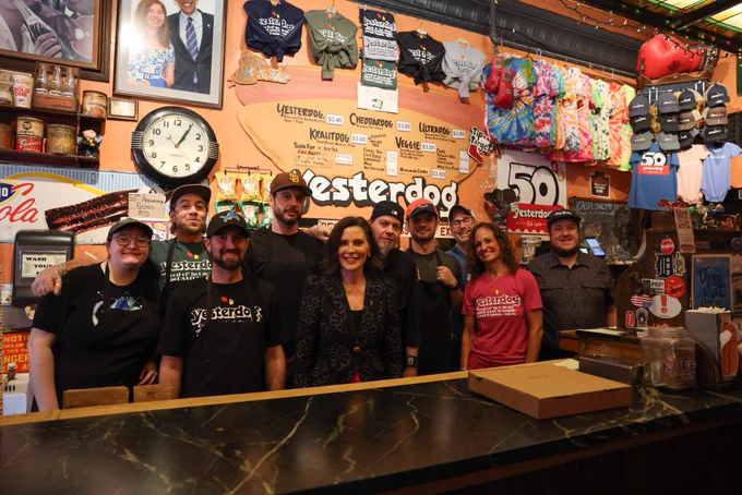 Gov. Whitmer takes a photo with the staff at Yesterdog.