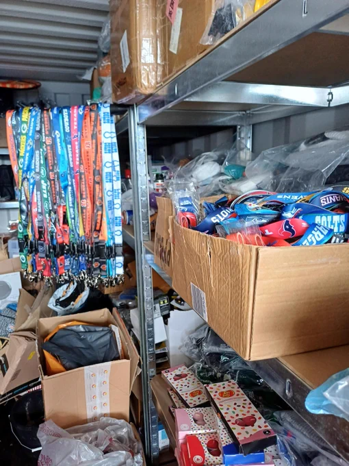 A storage unit filled with NFL team lanyards and other merchandise