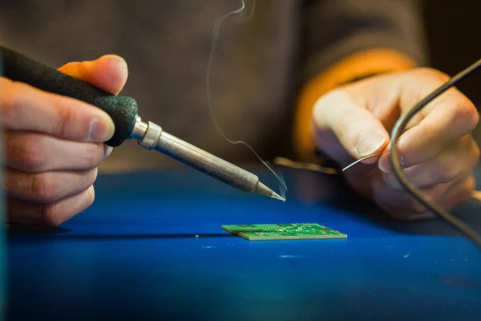 Edward Lee solders in the lab