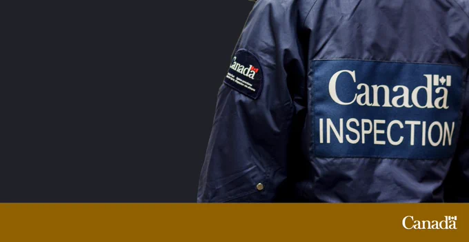  Close-up of a person wearing a Canadian Food Inspection Agency jacket.