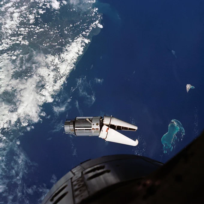 The Augmented Target Docking Adapter (ATDA) as seen from the Gemini-9 spacecraft during one of their three rendezvous in space. The ATDA and Gemini-9 spacecraft are 66.5 feet apart. Failure of the docking adapter protective cover to fully separate on the ATDA prevented the docking of the two spacecraft. The ATDA was described by the Gemini-9 crew as an "angry alligator." Photo credit: NASA