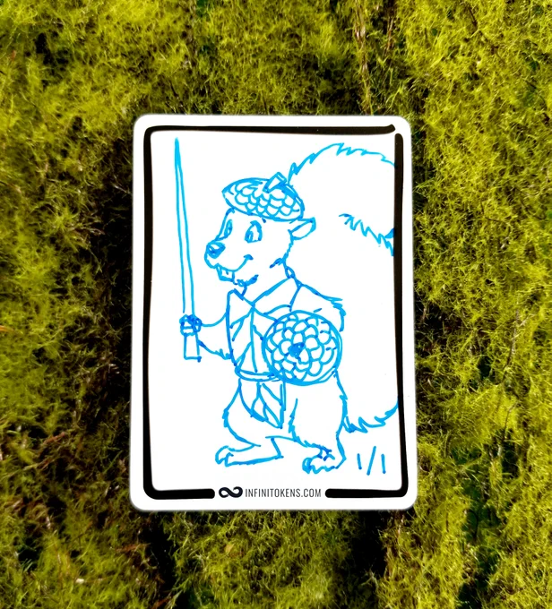 An InfiniTokens dry erase token with a 1/1 squirrel drawn on it that has an acorn cap helmet and shield, and it is carrying a sword that looks like a thorn.