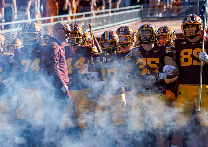 Coach P.J. Fleck in front of a row of Minnesota football players in 2025. 
