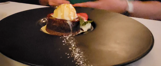 A choclolate lava cake with a scoop of Vanilla Gelato